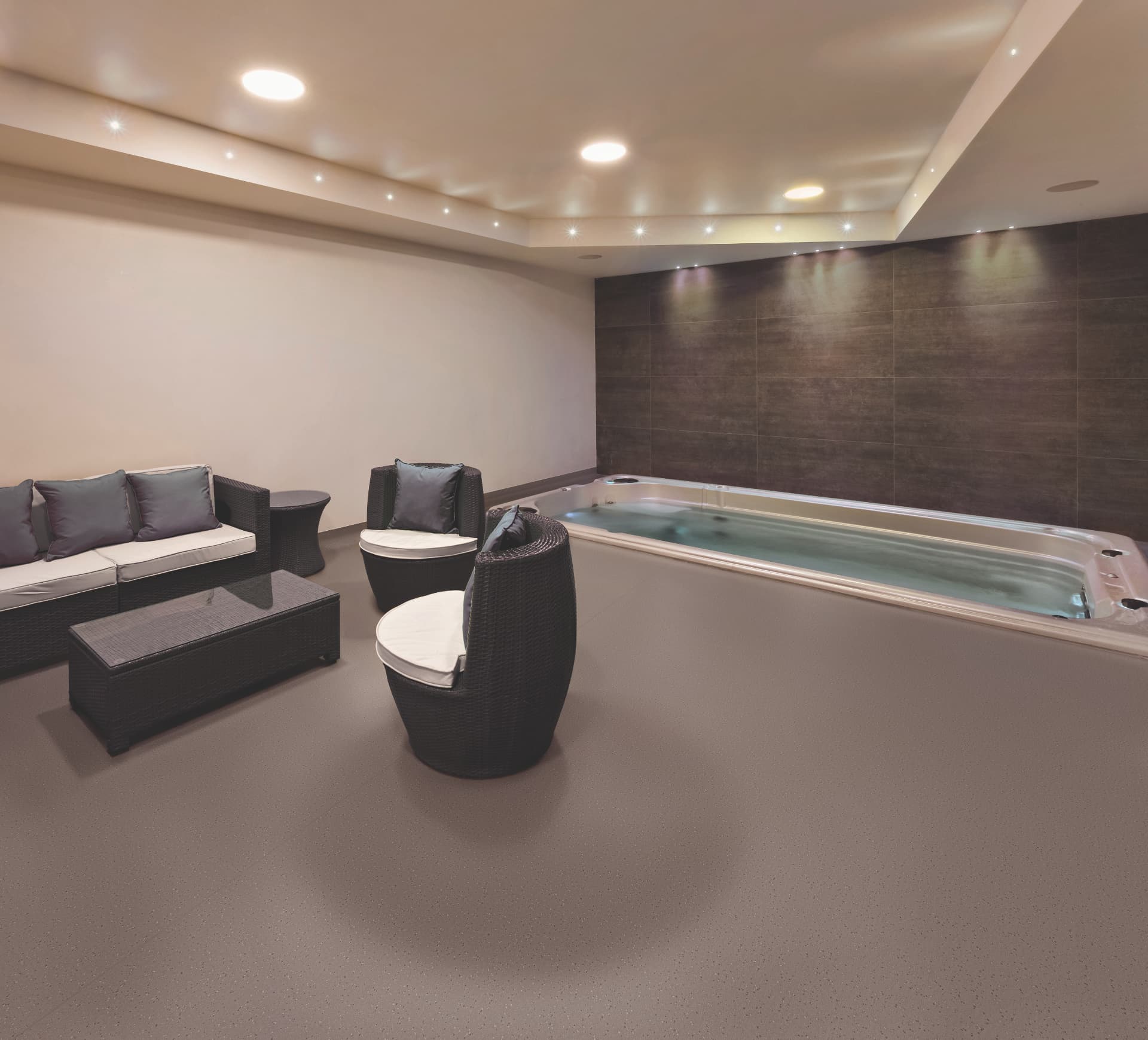 Private spa lounge with seamless resin flooring beside an indoor pool